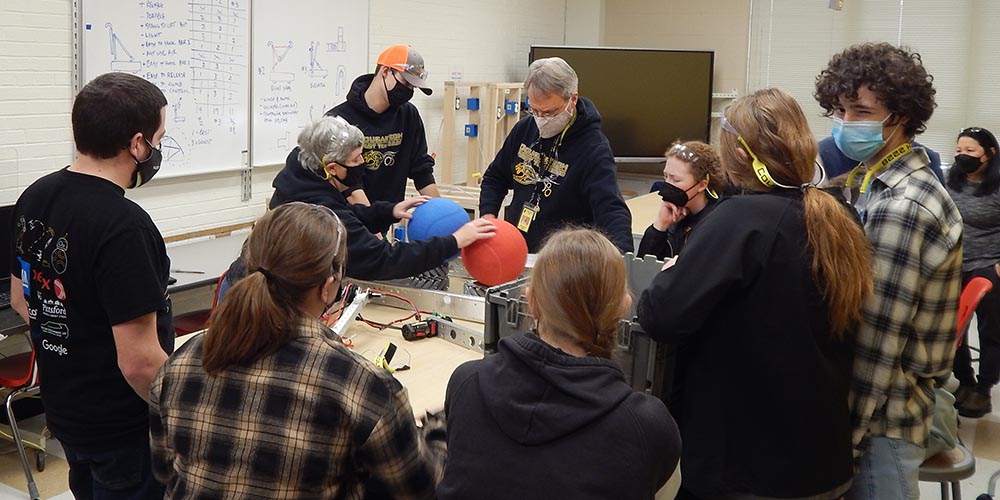 A picture of a mentor explaining a subject.